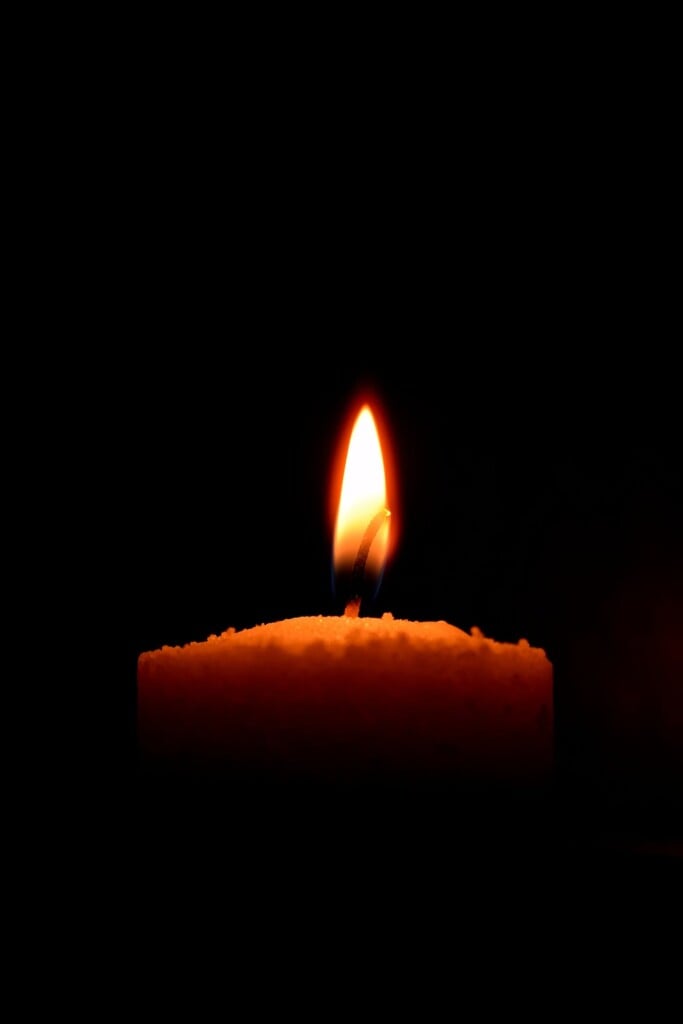 Candle on black background (Source: Pexels/Tuca Bianca)