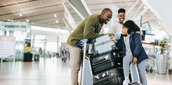 A family gathers with their luggage in an airport. (Source: BBB)