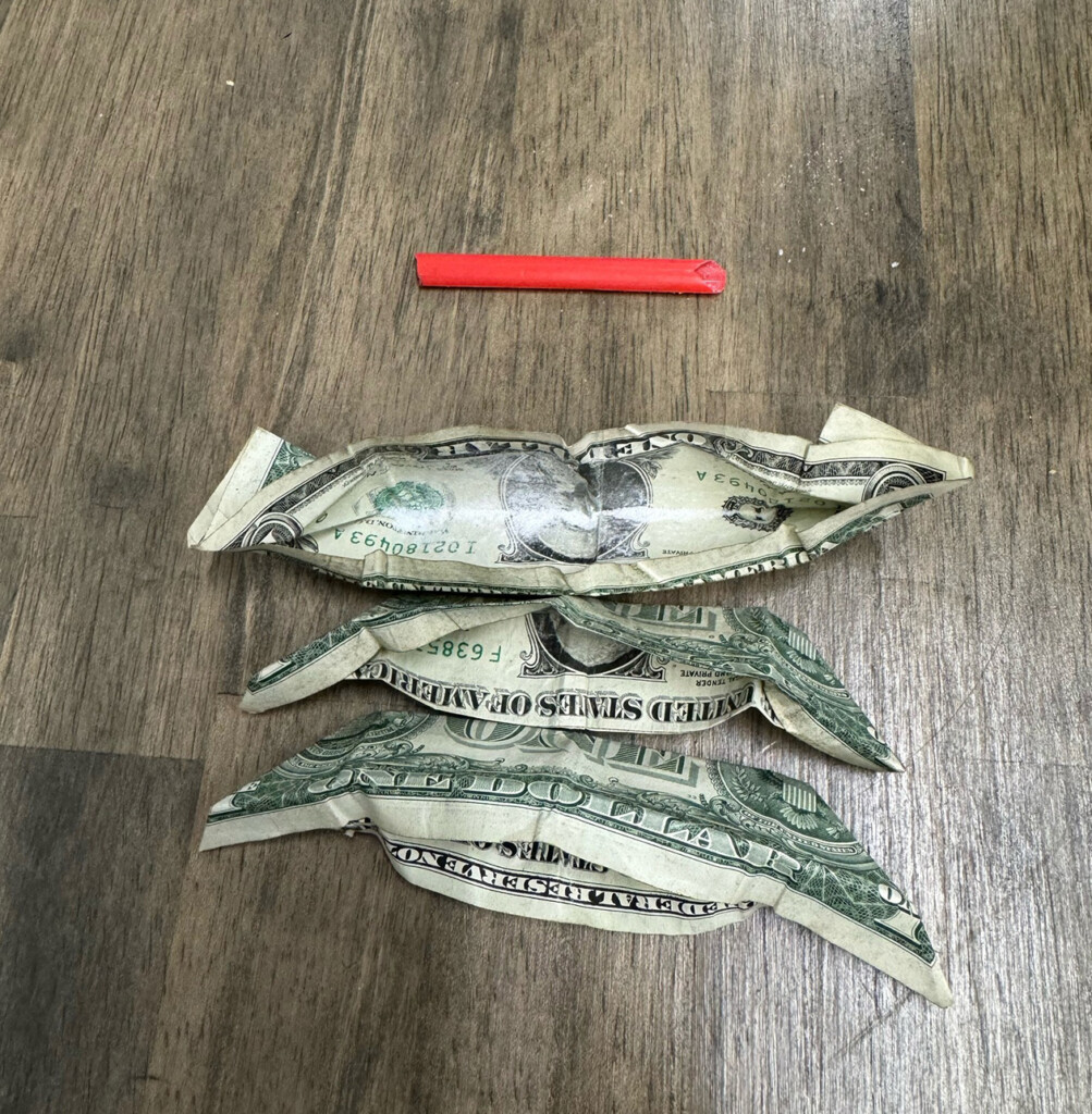 A sheriff's deputy says he found several folded dollar bills containing methamphetamine and a straw used for ingesting it. (Source: Graves County Sheriff's Office/Facebook)