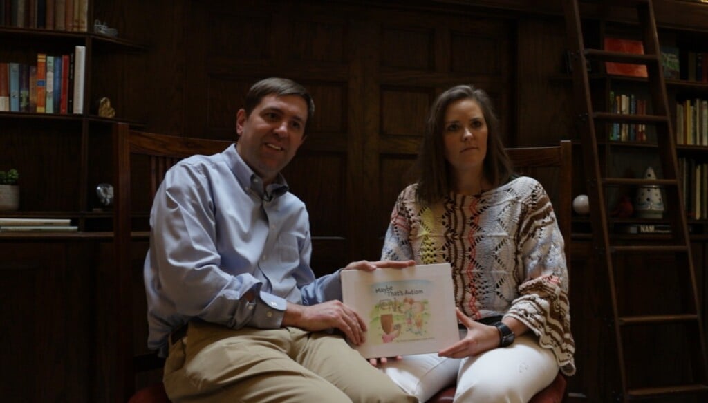 Taylor Crowe and Leah Ultich hold up the book they co-authored titled "“Maybe That’s Autism”.