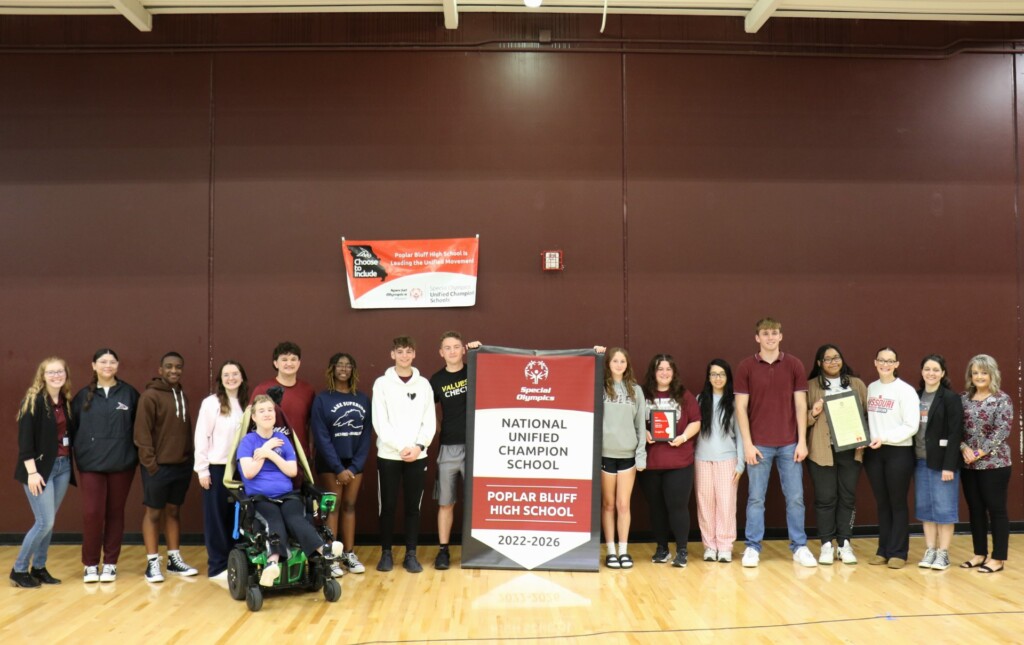PBHS Unified student leaders, teachers and administration pose with the National Banner and other prestigious awards at the conclusion of the school-wide assembly on Tuesday, May 7, in the gymnasium. (Source: Poplar Bluff R-I School District)