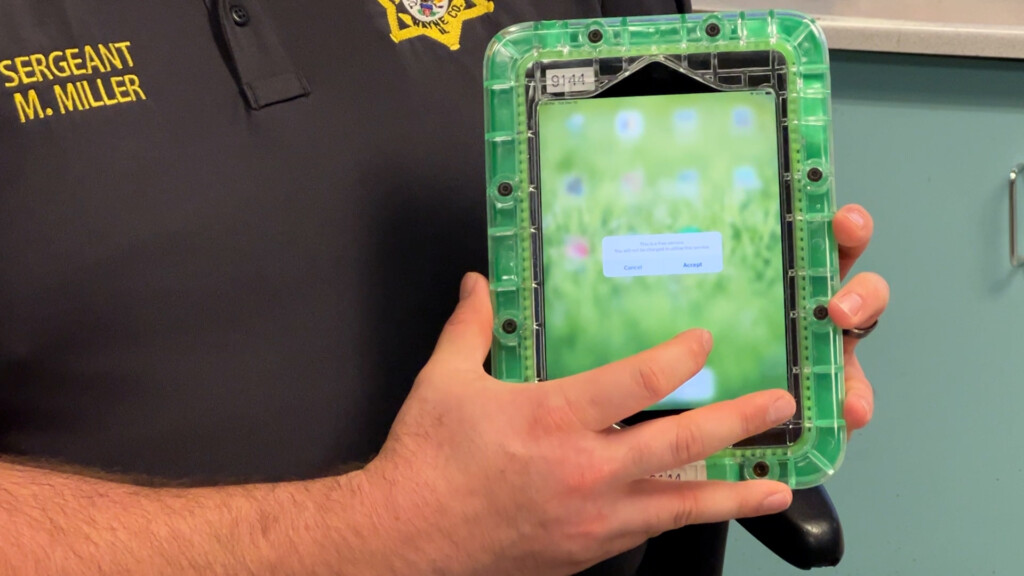 Sergeant Mike Miller shows a tablet inmates can use to access their mail