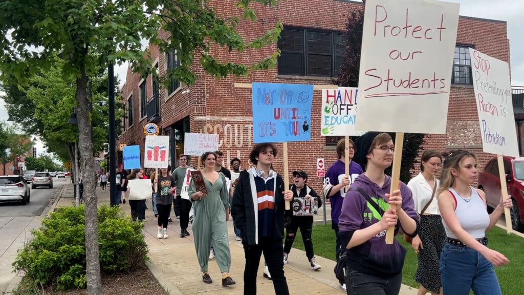 Students carrying protest signs.