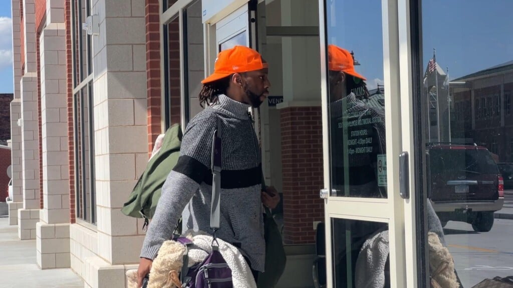 Man carrying luggage as he walks into new Amtrak station. Carbondale, IL. May 22, 2025.