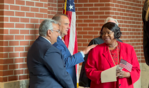 New US citizens, with Gov. Mike Kehoe