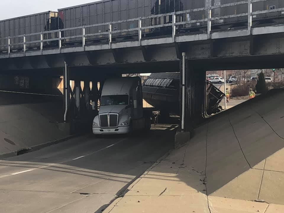 Semi-truck hauling rail car hits bridge, blocks road on Havelock