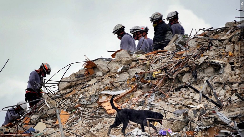Rescue workers dig through debris at the Surfside condo collapse