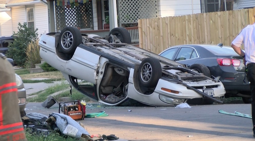 Car flips over after striking parked vehicle in central Lincoln