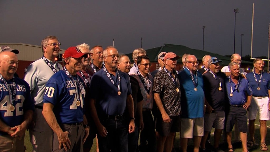 Lincoln East 1975 championship team accepting their new medals