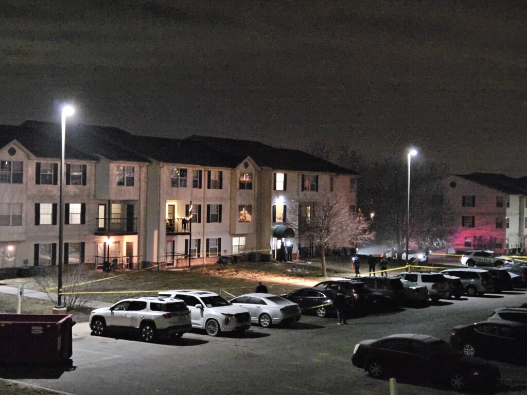 Police investigate outside an apartment building near 14th and Superior streets.