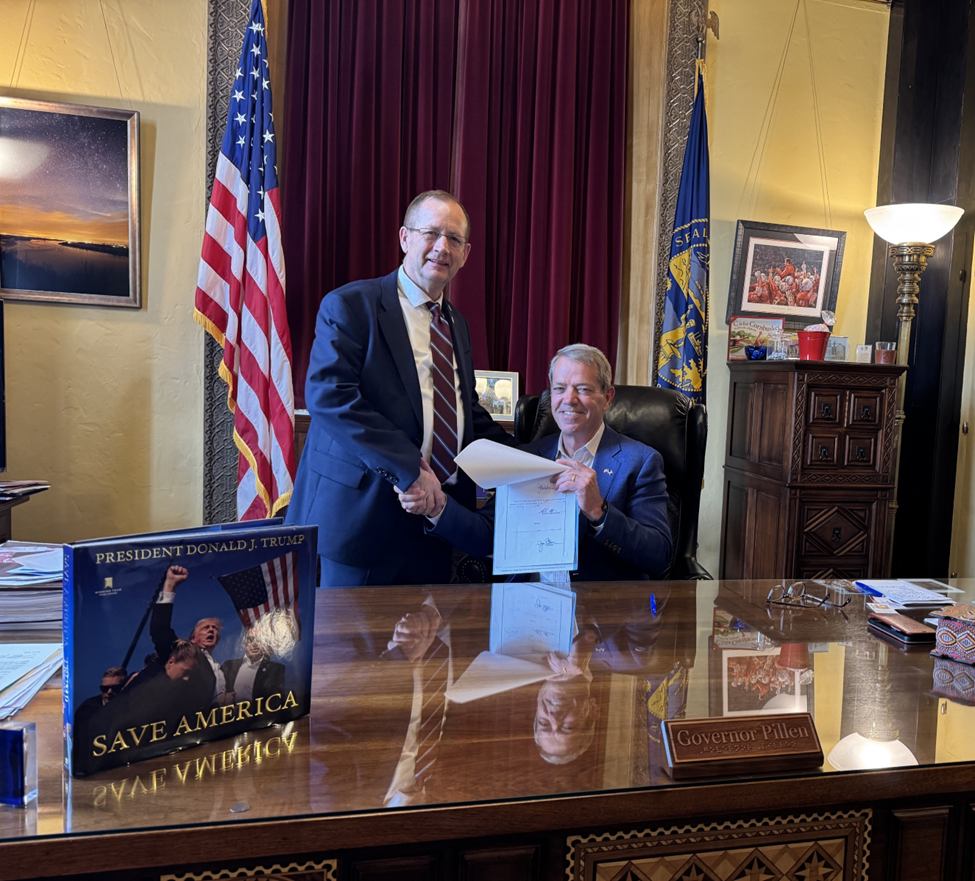 State Sen. Barry DeKay with and Gov. Jim Pillen shake hands after the signing of a bill banning lab-grown meat in Nebraska.