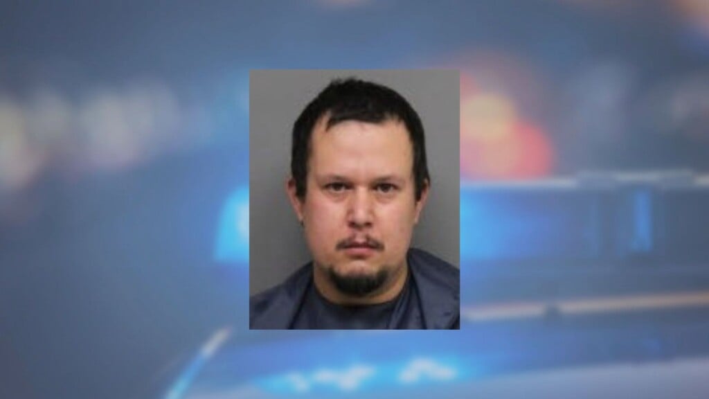 Mug shot in front of police sirens