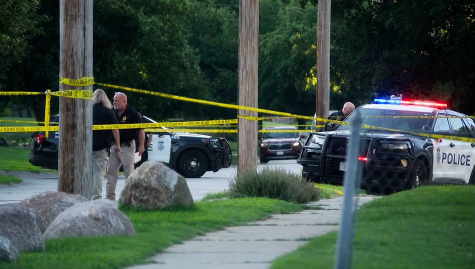 Yellow tape and police cars.