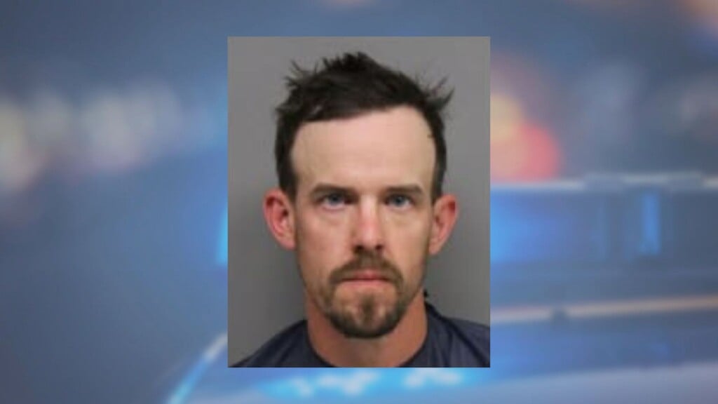 Mugshot over cop lights.