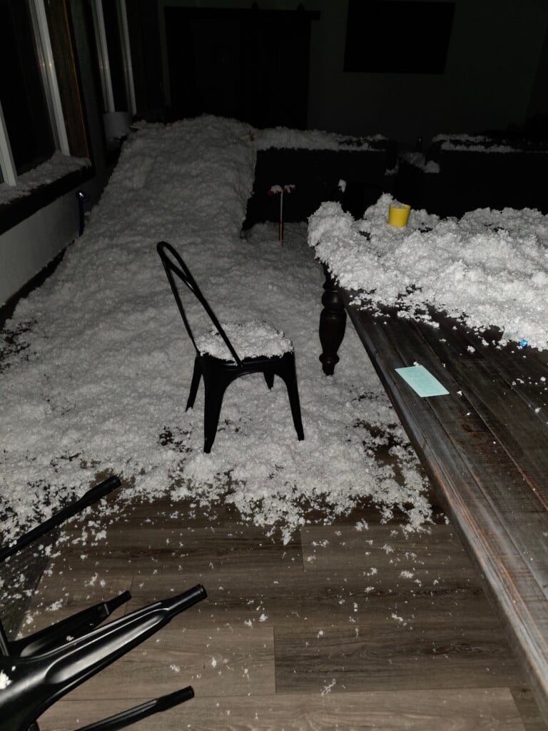 Chair and floor covered in hail and insulation