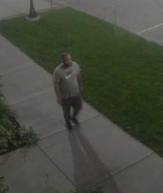 Suspect walking down a sidewalk