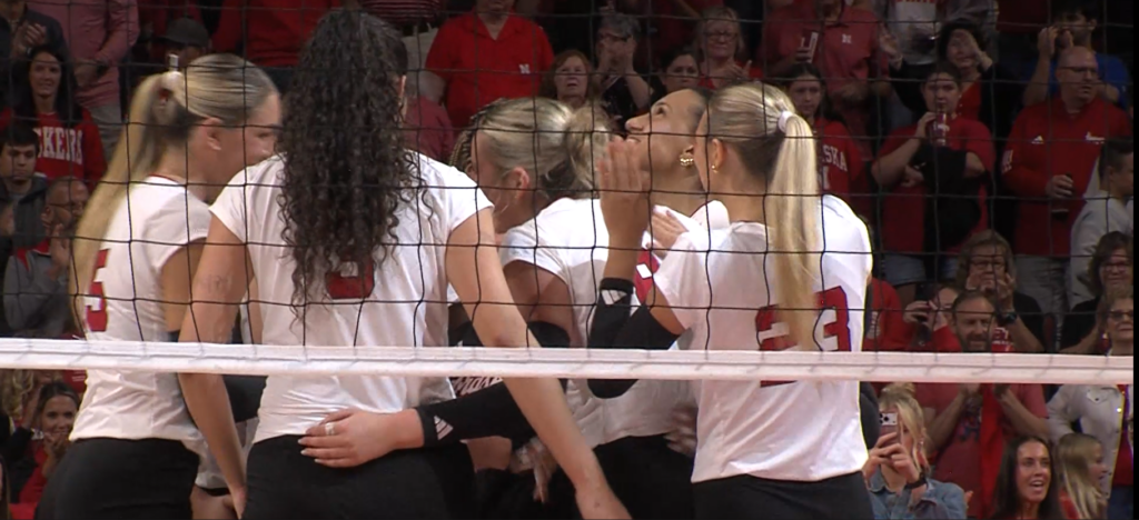 Nebraska celebrates a sweep of rival Creighton Sept. 16.