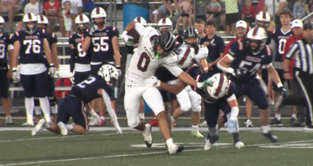 Waverly's Gavin McMillan stiff-arms a Norris defender in the team's 48-12 win.