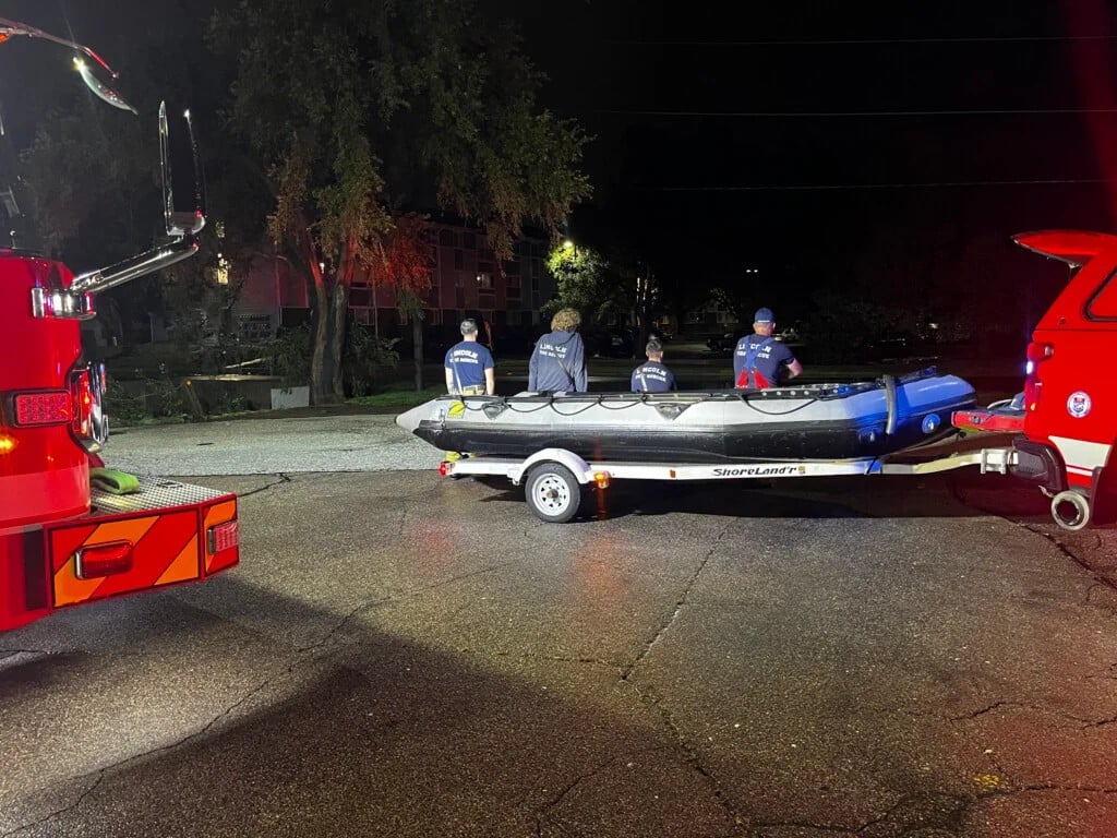Flooding in Lincoln, emergency personnel on boat