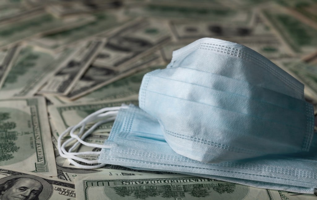 Edical Face Mask And Dollar Banknotes, World Coronavirus Epidemic And Economic Losses Concept.