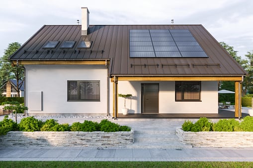 Modern House With Solar Panels And Wall Battery For Energy Storage.