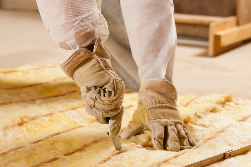 Man Cutting Insulation Material For Building Construction