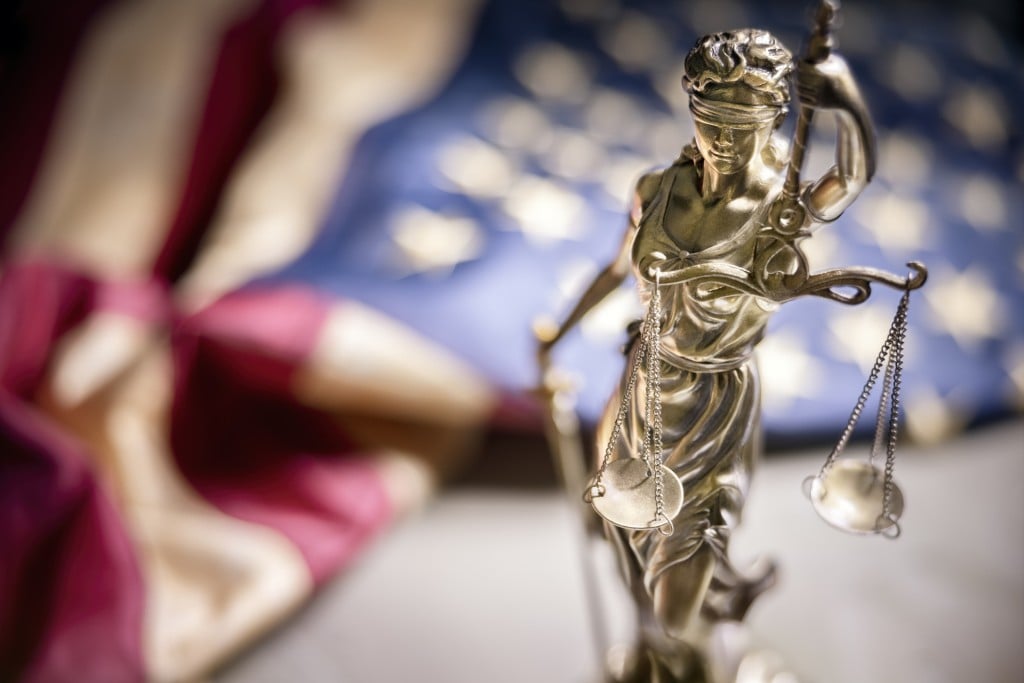 American Legal System Law Concept Statue Of Lady Justice With Scales Of Justice And American Flag