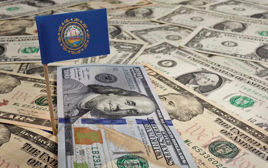 Flag Of New Hampshire Sticking In Various American Banknotes.(se