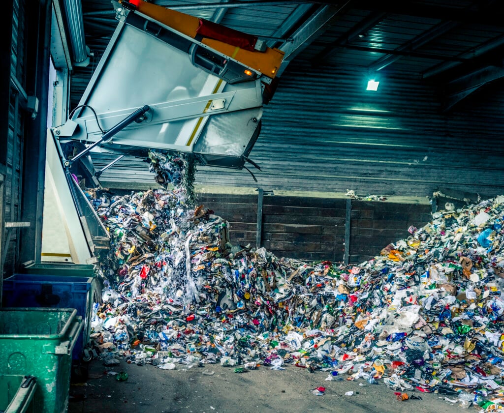 Tipping Recycling Into Storage Shed