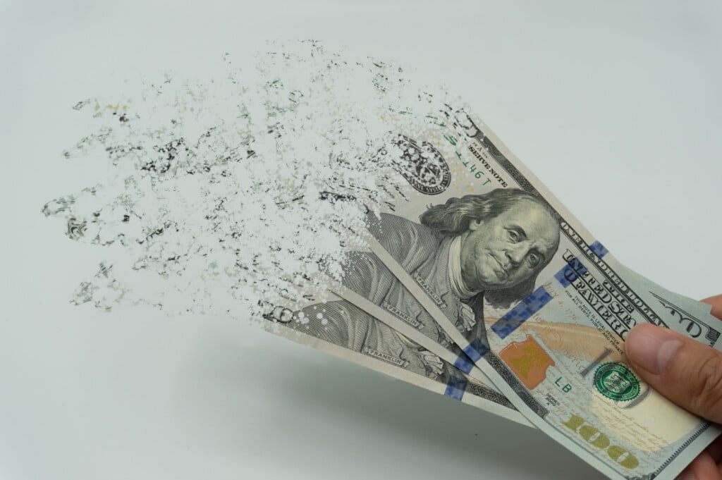 The Man's Hand Holds A 10000 Korean Won, Which Crushes And Flutters In The Wind. The Concept Of Currency Devaluation And Economic Crisis.collapse, Stagnation ·economy.spending And Loans,covid 19.