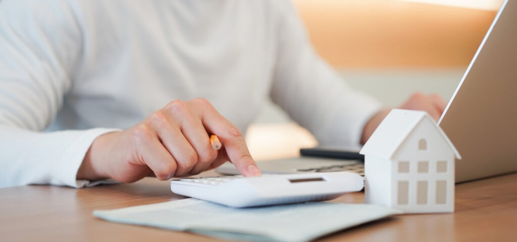 Close Up Young Man Hand Press On Calculator To Check And Summary Expense Of Home Loan Mortgage For Refinance Plan , People Lifestyle Concept