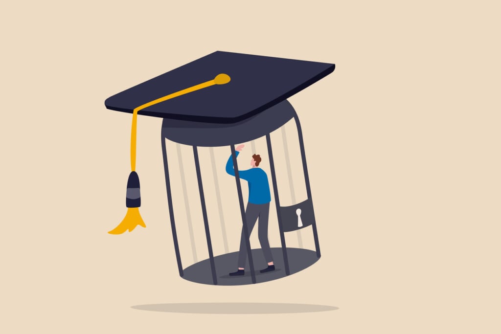 Student Loan Debt, Money Trap That Graduated Have To Payback Huge Amount Of Money, Expensive Cost For Education Concept, Depressed Confused New Graduated Student In Birdcage With Graduation Cap.