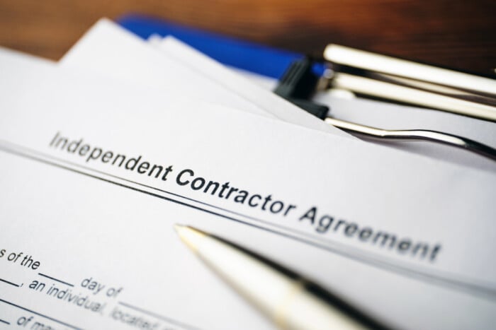 Legal Document Independent Contractor Agreement On Paper Close Up