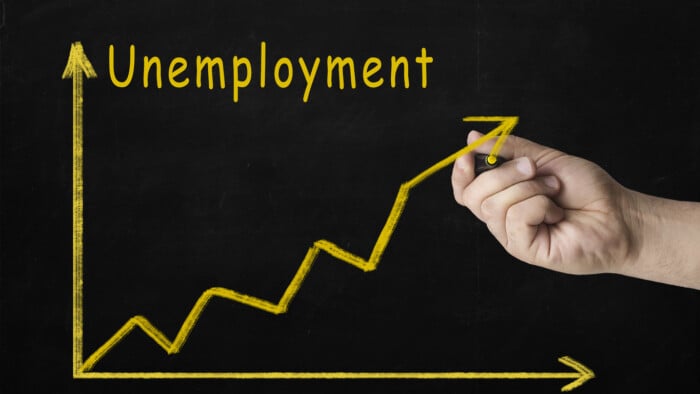 Rising Unemployment Rates. Image Of A Businessman Hand Make A Chart Of Unemployment Rate With Growing Arrow On Blackboard