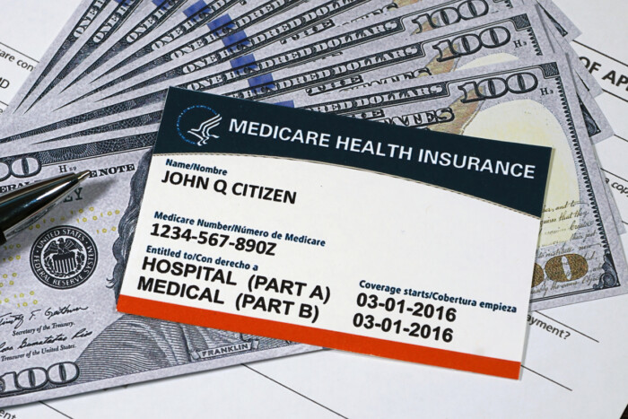 Fake Medicare Card With Fake Us Currency And Pen.