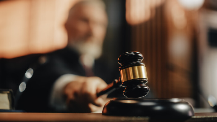 Court Of Law And Justice Trial Session: Imparcial Honorable Judge Pronouncing Sentence, Striking Gavel. Focus On Mallet, Hammer. Cinematic Shot Of Dramatic Not Guilty Verdict. Close Up Shot.