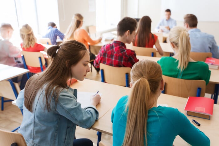 Group Of Students Writing School Test