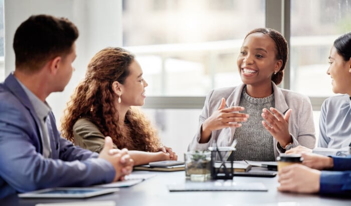 Discussion, Meeting And Business People In Office For Teamwork, Planning Or Review At Table. Collaboration, Professional And Group Of Diverse Employees For Ideas, Conversation Or Project Development