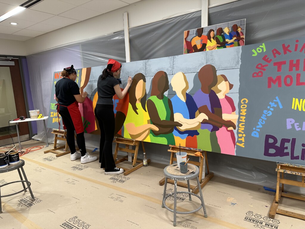 Participants Painting The Community Mural