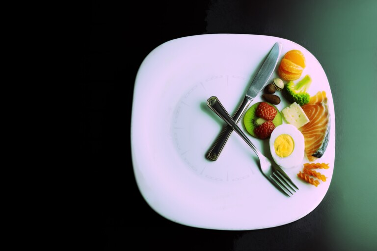 A Plate Simulating A Clock With The Hands Of A Fork And A Knife Showing Food, Concept Of Intermittent Fasting