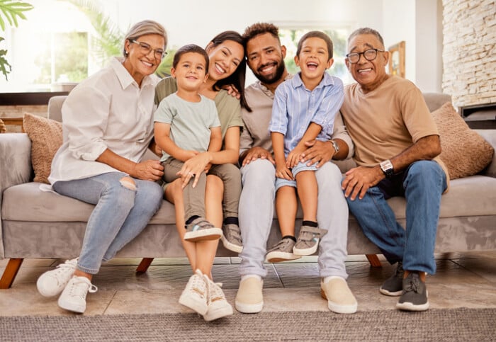 Big Family, Children Or Bonding On Sofa In House Or Home Living Room With Senior Grandparents, Mother Or Father. Smile, Happy Or Multi Generation Family Of Retirement Elderly, Men And Women With Kids