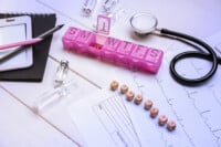 Word Hormones With Medical Supplies On White Wooden Background,