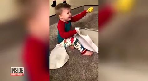 2-year-old boy in awe of banana he got for Christmas