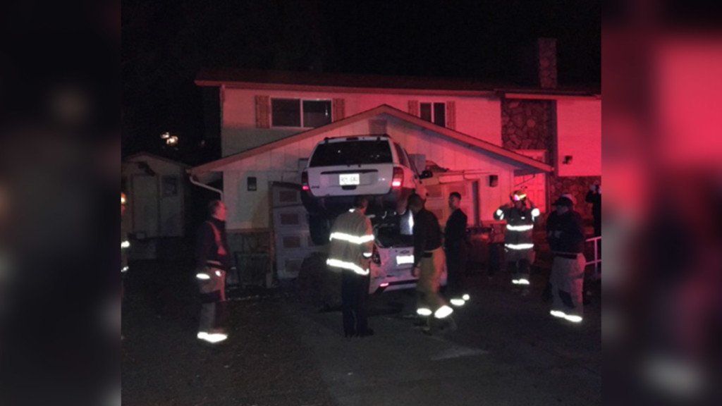 Police: Car stuck on top of another car, lodged into garage