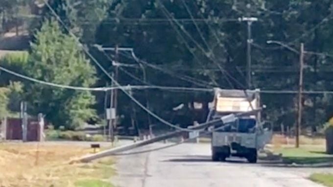 Garbage truck runs into power lines along Thorpe Rd in Spokane Valley