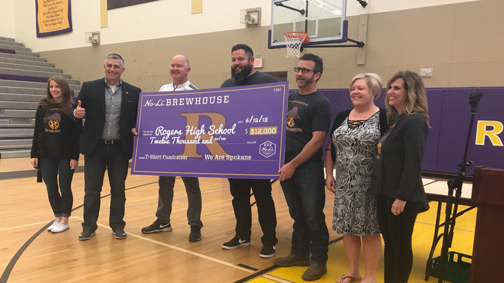 No-Li Brewhouse presents Rogers High School with $12,000 check for new football uniforms