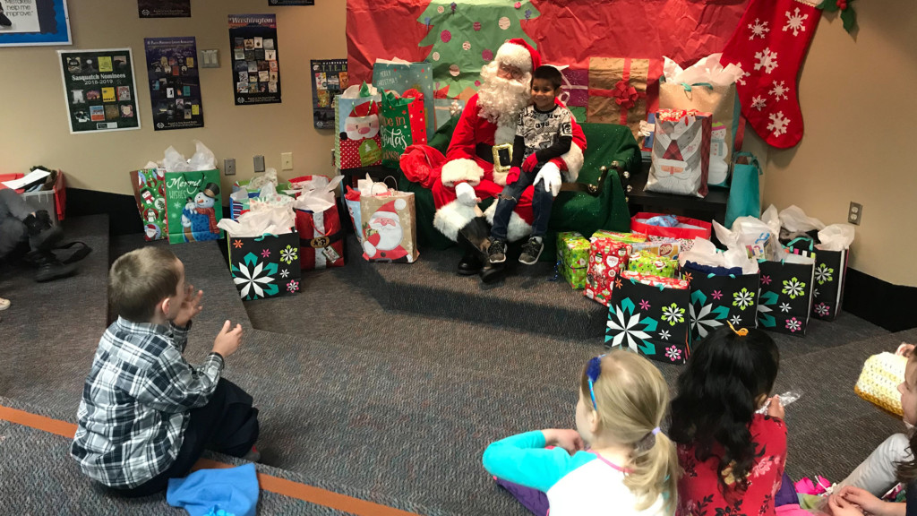 Santa Claus stops by Longfellow Elementary with new coats and hats for 100 kids