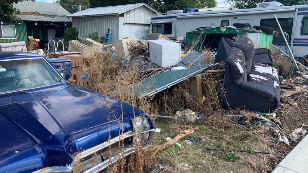Homeowners say City of Spokane won’t do anything about trash build-up in neighbor’s yard