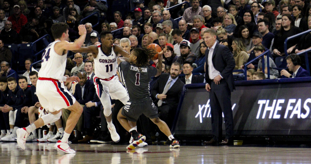 Gonzaga's Joel Ayayi steals the ball from a Santa Clara player while Gonzaga coach Mark Few looks on with approval.