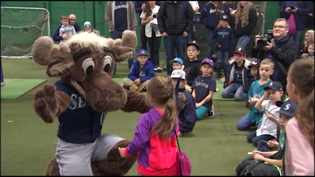 The Mariners Moose giving a hug to a young fan in Spokane
